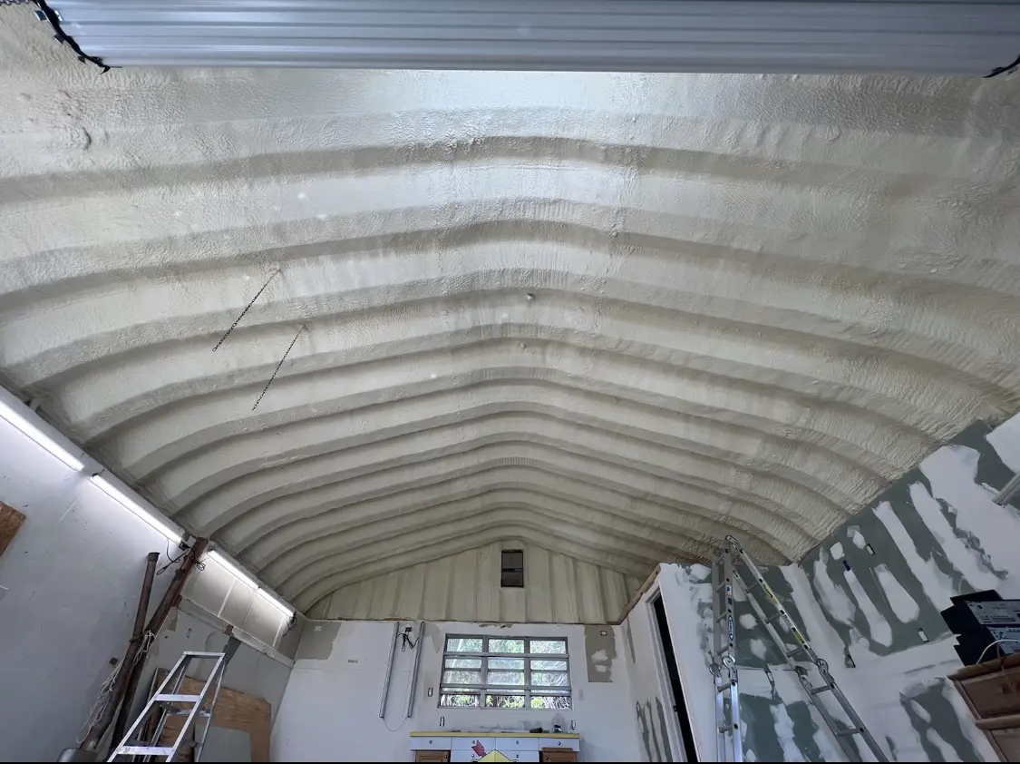 Spray polyurethane foam applied to the underside of a metal roof deck in Rose Hill
